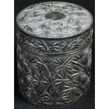 A Chinese silver cylindrical pot and cover, chased with a dense field of sprouting bamboo, 7.1cm