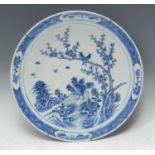 A Chinese circular charger, painted in tones of underglaze blue with cockerels, song birds,