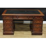 A Victorian mahogany twin pedestal desk, rounded rectangular top with inset leather writing surface,