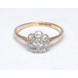 An 18ct gold diamond flower head cluster ring, central round old brilliant cut diamond surrouinded
