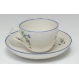 A Pinxton teacup and saucer, pattern 13, decorated with chantilly sprigs, blue line rims, 1796 -