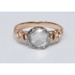 A diamond solitaire ring, round rose cut diamond approx 0.54ct, white metal collar, open cast rose