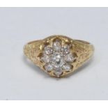 A nine stone diamond floral cluster ring, central old cut diamond surrounded by eight smaller old