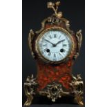 A French gilt metal mounted boulle cartouche shaped mantel clock, 9cm circular dial inscribed with