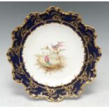 A Royal Crown Derby shaped circular plate, painted by Charles Harris, signed, with fanciful birds,