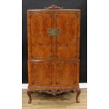 A Queen Anne Revival burr walnut cocktail cabinet, rectangular doors enclosing a fitted interior,