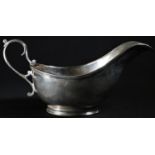 A George V silver sauceboat, divided scroll-capped handle, 21cm long, James Dixons & Sons, Sheffield