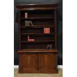 A Victorian mahogany library bookcase, concave outswept cornice above adjustable shelves flanked