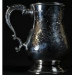 A Victorian provincial silver bell shaped mug, wriggle-work engraved with scrolling foliage,