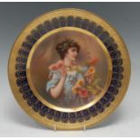 A Vienna circular plate, Chrysanthemums, decorated with a beauty with laurel chaplet with flower