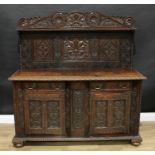 An 19th century oak sideboard, an Antiquarian 'fantasy', shaped cresting above three panels, the