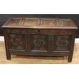 An early 18th century oak blanket chest, hinged four-panel top enclosing a till, the four panel
