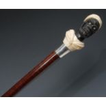 A late 19th century gentleman's novelty silver-mounted ebony, ivory and snakewood walking cane,