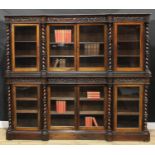 A Victorian rosewood inverted break-centre library bookcase, deep frieze carved in relief with