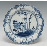 An 18th century Liverpool small scalloped plate, painted with bamboo and flowering plants, 16cm