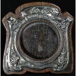 An Art Nouveau silver shaped rectangular easel photograph frame, embossed with flowers and sinuous