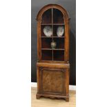 A Queen Anne style walnut corner china closet, arched top above a glazed door, slightly projecting