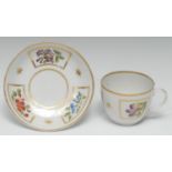 A Pinxton Bute-shaped teacup and saucer, painted with cornflowers and other country flowers in blue,