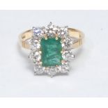An emerald and diamond cluster ring, central rectangular cushion cut emerald, approx 1.30ct,