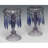 A pair of early 20th century lilac glass lustres, everted rims, facetted columns, shaped domed
