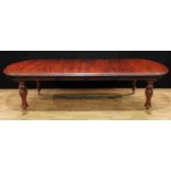 A William IV style mahogany rounded rectangular wind-out dining table, two additional leaves, turned