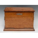 A late 19th century oak stationery box, the interior with inkwell, waterfall letter rack, writing