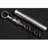 A George III silver coloured metal pocket picnic corkscrew, of peg and worm form, 5cm steel worm,