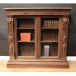 A 19th century Italian Renaissance Revival walnut bookcase, rectangular top above a pair of frieze