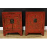 A pair of Chinese red lacquer side cabinets, each with a pair of doors, decorated with monumental