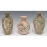 A pair of Langley Ware ovoid vases, incised with white blossom and foliage, with ladybird, 20cm