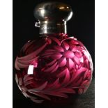 An Elizabeth II silver mounted cranberry glass globular scent bottle, cut with flowers and scrolling