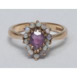 A George V lady's 9ct gold, amethyst and opal dress ring, pear-shaped amethyst claw set and within a