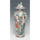 A Chinese baluster vase and cover, painted in the famille verte palette with peacocks and blossoming