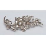 A naturalistic diamond encrusted floral leaf brooch, pave encrusted with round, oval, cushion and