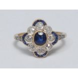 An Art Deco style diamond and sapphire cluster ring, central oval blue sapphire, surrounded by a
