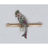 A diamond emerald, ruby and seed pearl parrot brooch, pave encrusted with nineteen mixed cut