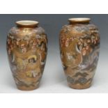 A pair of Japanese satsuma ovoid vases, painted with scrolling dragon and oriental figures, 32.5cm