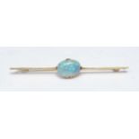 A black opal bar brooch, central oval black opal doublet measuring approx 13mm x 10mm x 5.5mm,