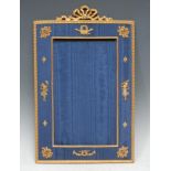 A French gilt metal mounted and watered blue silk easel photograph frame, ribbon cresting, applied