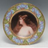 A Vienna type plate, decorated with a Pre-Raphaelite beauty, the rim in polychrome with purple and