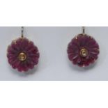 A pair of diamond and red stone floral earrings, carved flecked red stone flowerhead inset with a