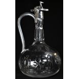 A Victorian silver mounted cut glass onion shaped claret jug, hinged cover surmounted by a canine