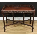 A Chinese hardwood butler's tray, pierced gallery, folding stand, carved throughout with fruiting