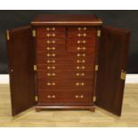 A Victorian style mahogany floor standing collectors cabinet, rectangular top above a pair of