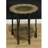 A Chinese hardwood and brass folding occasional table, the shaped circular plateaux engraved with
