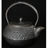 A Japanese cast iron kettle, arched swing handle, 13cm long