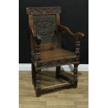An '18th century' oak Wainscot armchair, slightly oversailing cresting rail carved with scrolling