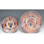 A large Japanese fluted Imari shaped circular charger, 39cm diam, Meiji period; another, smaller,
