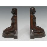 A pair of 19th century bronze bookends, cast as kneeling Egyptian ladies, 19cm hihg, retailed by