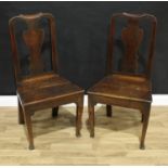 A pair of mid-18th century oak side chairs, shaped vasular splats, boarded seats, square section